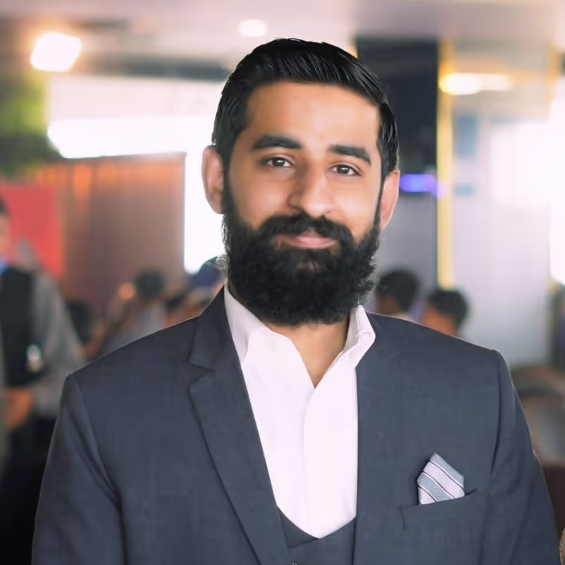 A man with a beard wearing a suit.